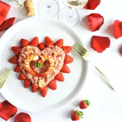 Un cuore di risotto alle fragole, decorato con gamberi e fragole fresche, pronto per un'occasione speciale.