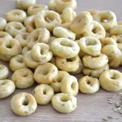 Taralli pugliesi ricetta originale: tanti piccoli anelli dorati, croccanti e profumati, pronti per essere gustati.