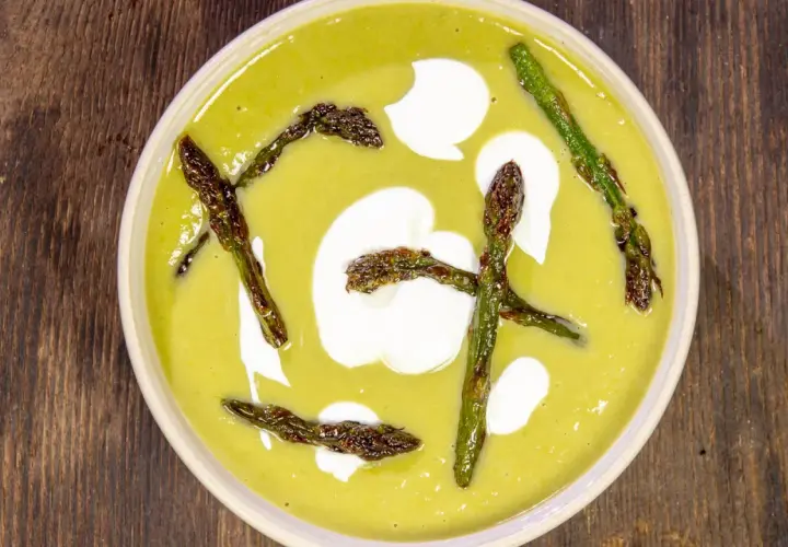Crema di asparagi vellutata con asparagi arrostiti e un tocco di panna.