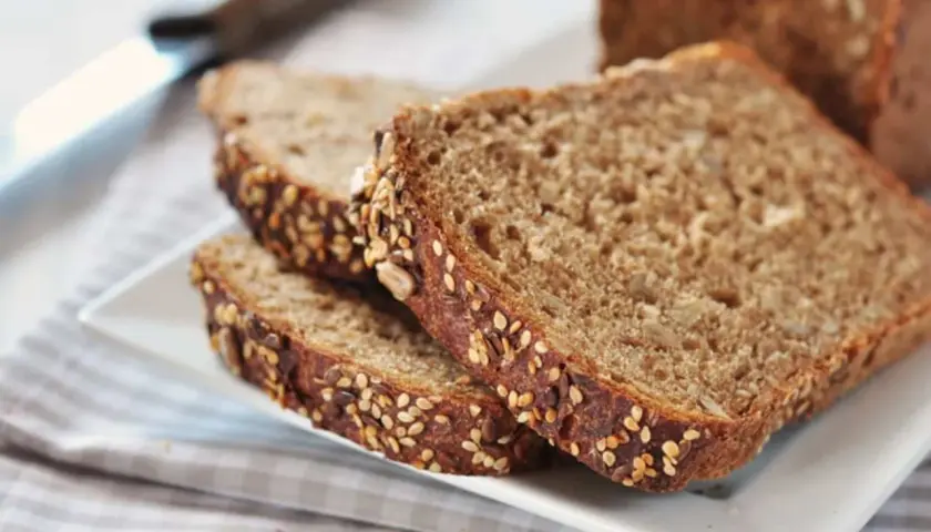 Fette di pane integrale con semi misti, perfette per una ricetta sana e gustosa.