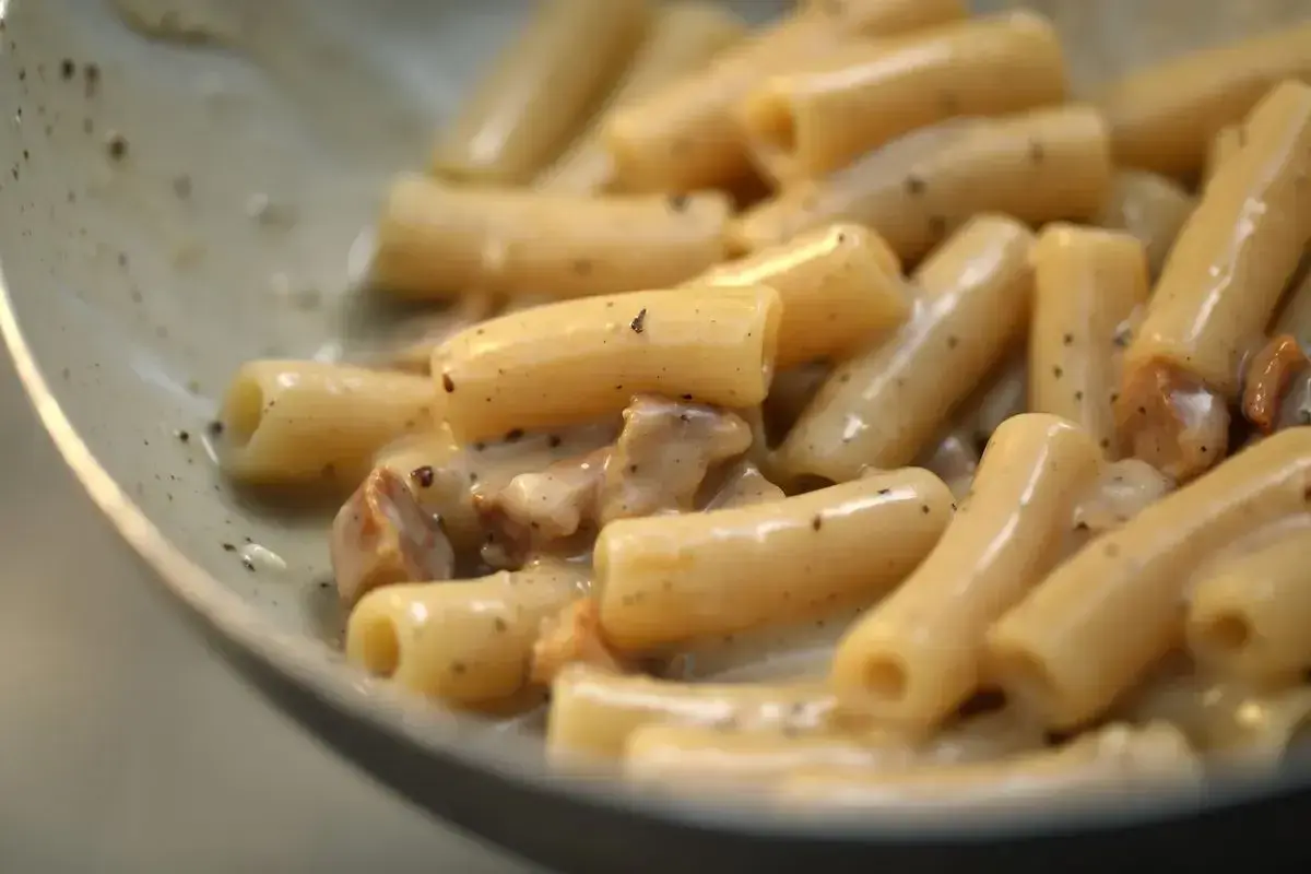 Primo piatto di pasta alla gricia, con rigatoni cremosi e guanciale croccante.