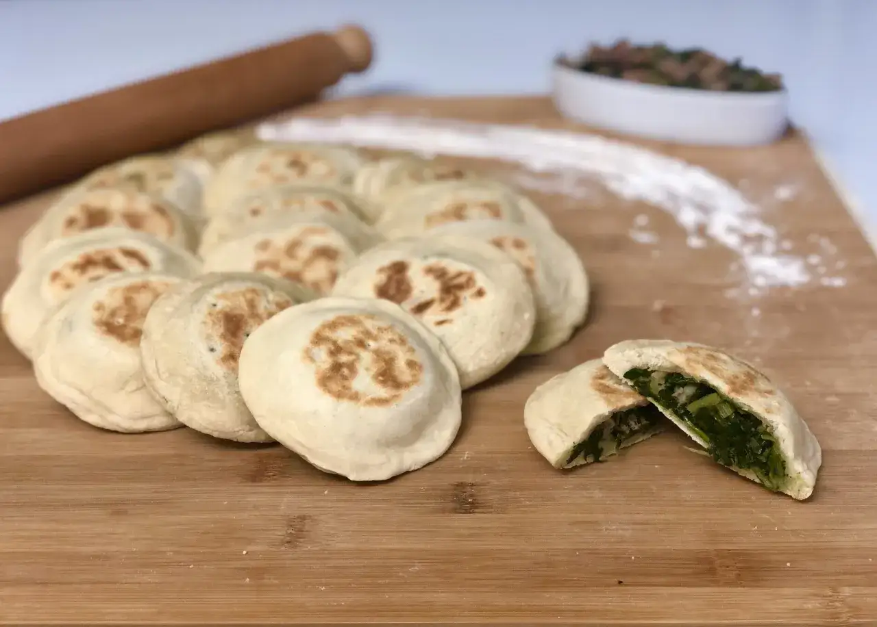Focaccine in padella pronte per essere gustate, con un ripieno verde e saporito.
